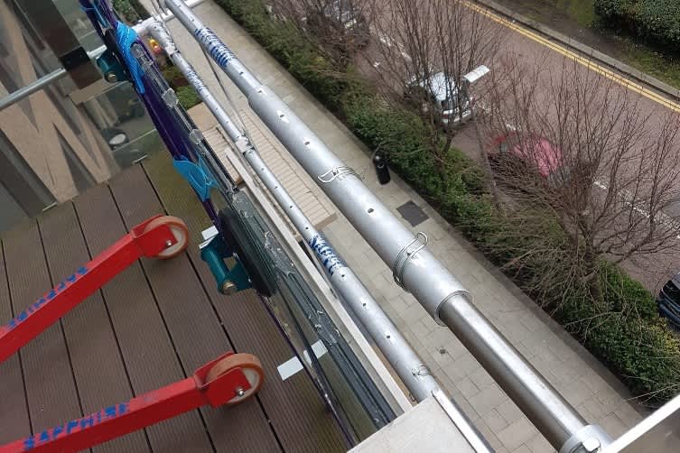 replacing vandalised glass on balcony in Greenwich using specialist equipment